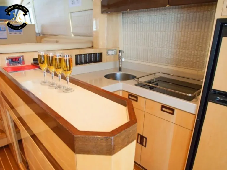 Dubai Fishing Trip. Elite 12 Majesty 56 FT with glasses with drinks inside the kitchen.